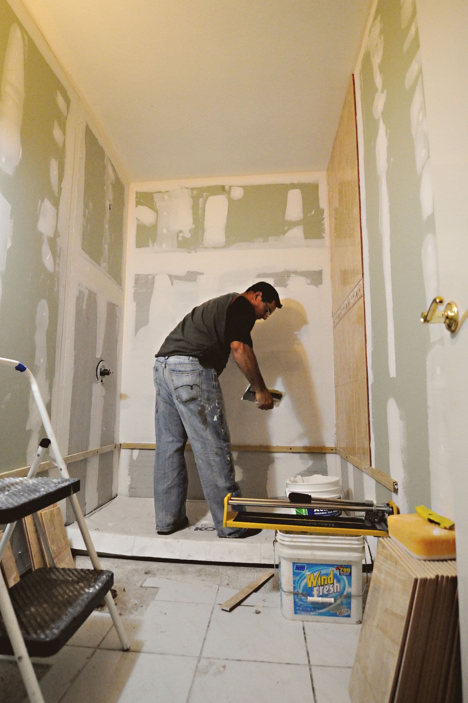 Plasterer applying compound to a wall during a renovation