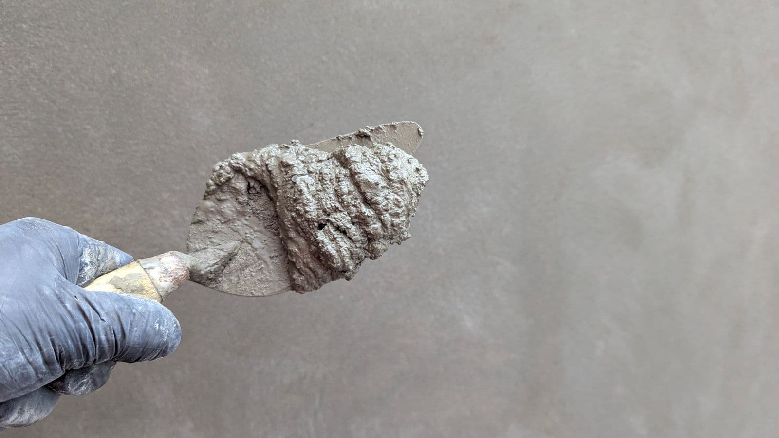 Close-up of a trowel loaded with compound