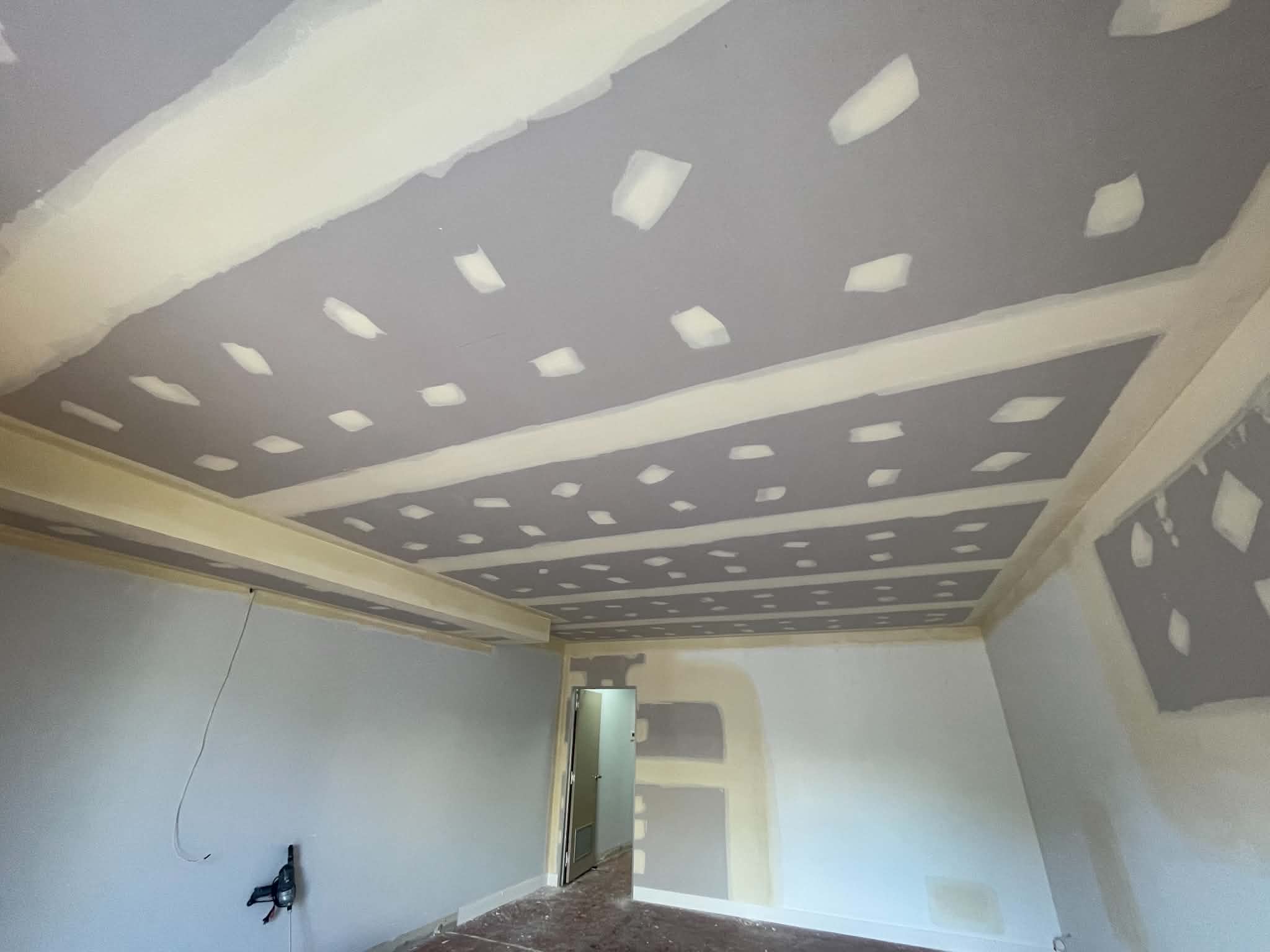 Ceiling mid-plaster with joints and screw heads taped and first-coated